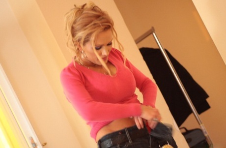 Older blonde Sharon Pink sets her fake tits loose while getting changed