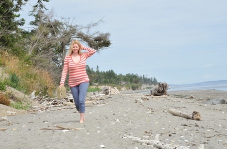 Busty mature woman Tasty Trixie goes barefoot at beach while exposing herself