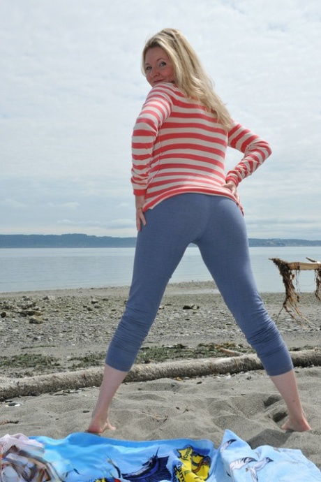 Busty mature woman Tasty Trixie goes barefoot at beach while exposing herself
