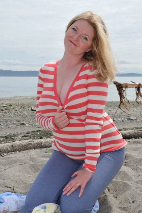 Busty mature woman Tasty Trixie goes barefoot at beach while exposing herself