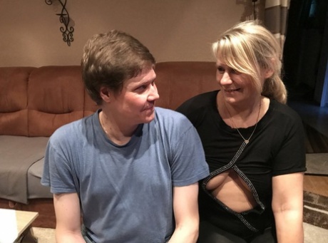 Blonde cougar gets cum in her eye after sucking off her stepson in tight pants