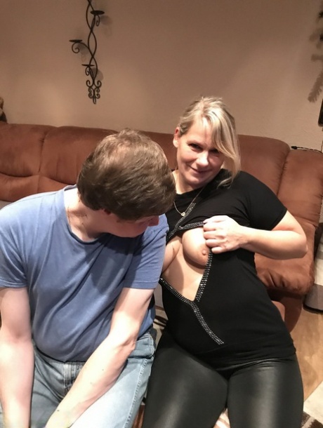 Blonde cougar gets cum in her eye after sucking off her stepson in tight pants