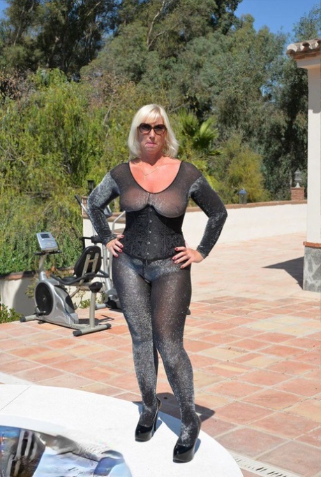 Aged amateur Melody takes off her heels before a swim in a bodysuit and shades