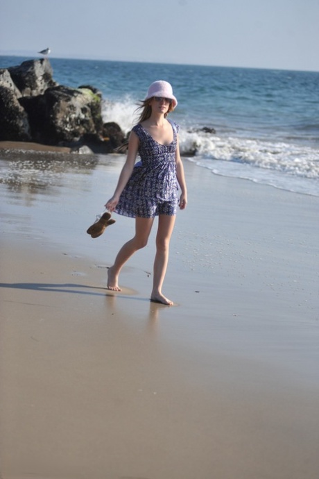 Glamour girl Sarah James flashes her upskirt underwear while at the seaside