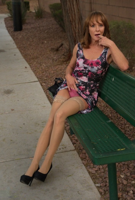 Aged lady flashes her tits and twat on a public bench before disrobing at home