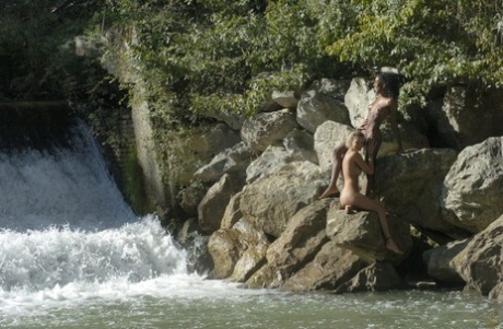Interracial lesbians Channone & Maeva go nude while in the water