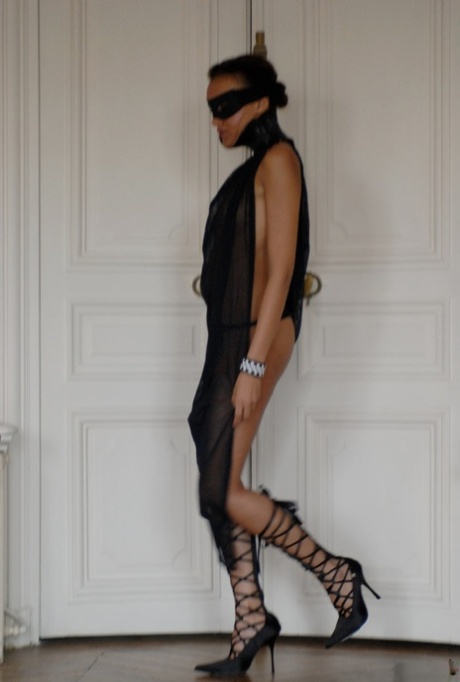 Brazilian female Angelique exposes her long legs while wearing a mask