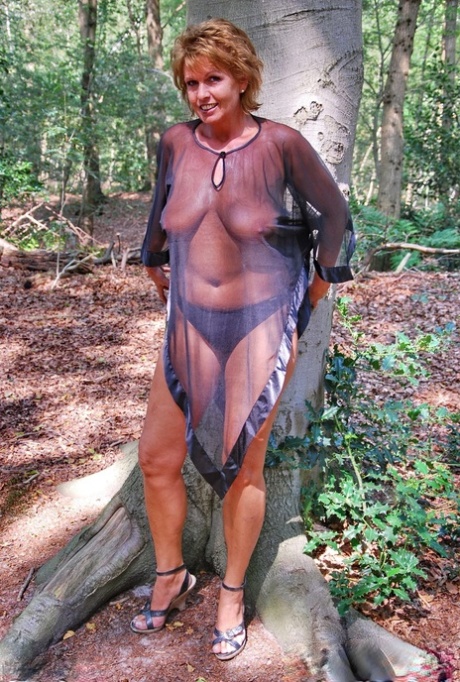 Hot older woman Luscious Models wears see thru attire while in the woods