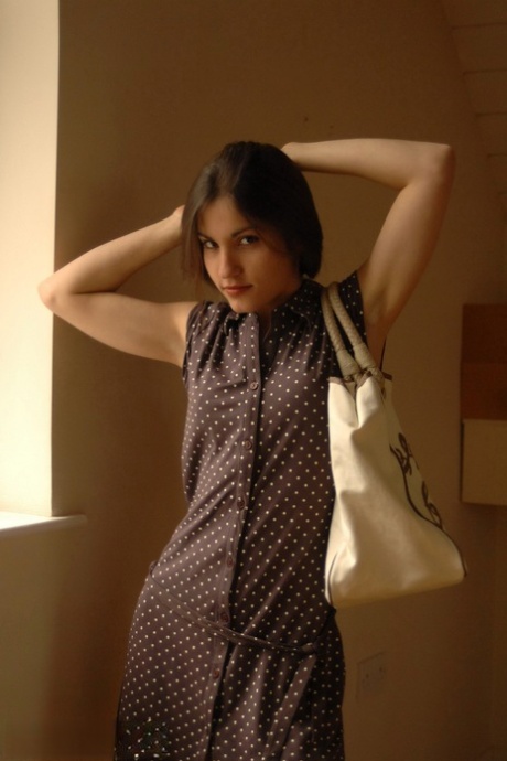 Pretty girl Steffi displays her tight ass after getting undressed by a window