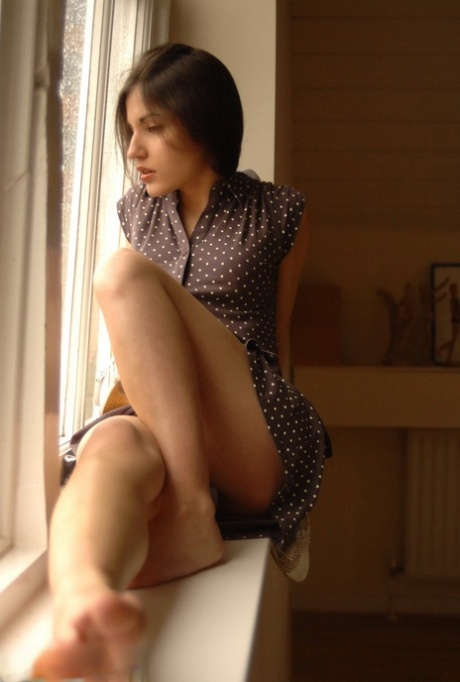 Pretty girl Steffi displays her tight ass after getting undressed by a window