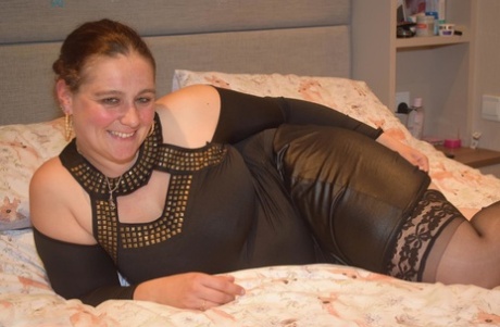 Middle-aged BBW gets completely naked on top of her bed for her first nudes