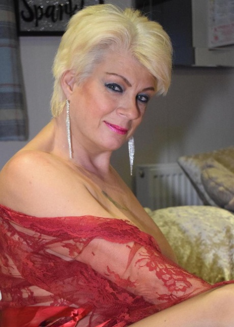 Mature blonde woman Dimonty looses her saggy tits from a sheer robe