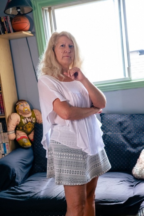 Older blonde Annie Griffith and her man friend have sex on a sofa