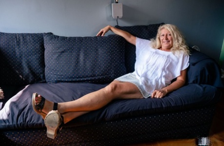 Older blonde Annie Griffith and her man friend have sex on a sofa
