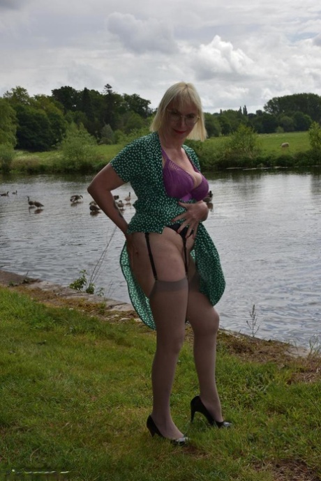 Older blonde Barby Slut flashes her tits and pussy while out in the country