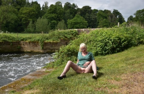 Older blonde Barby Slut flashes her tits and pussy while out in the country