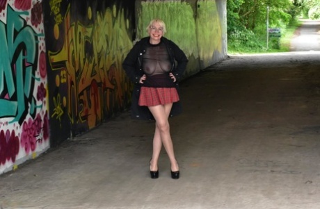 Mature British woman Barby Slut flashes her tits and ass in public places