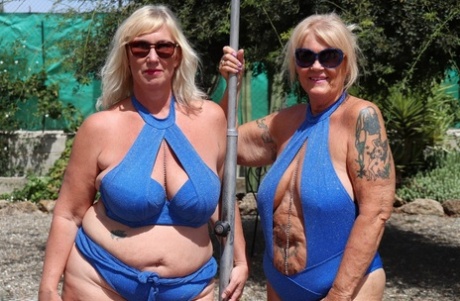 Overweight mature blonde lesbians fool around with each other in a backyard