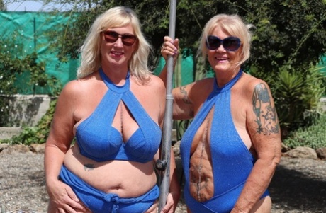 Overweight mature blonde lesbians fool around with each other in a backyard