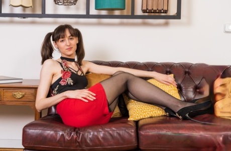 Solo girl Zlata removes her clothing while wearing a garter belt and nylons