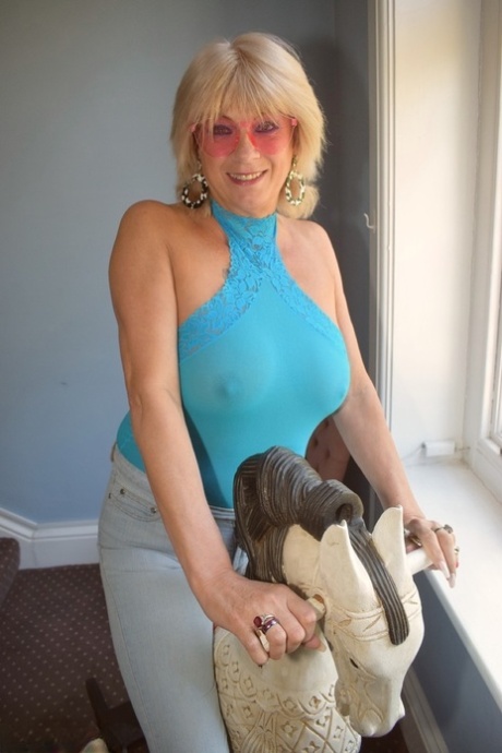 Mature blonde woman shows her tits and pussy after eating an ice cream treat