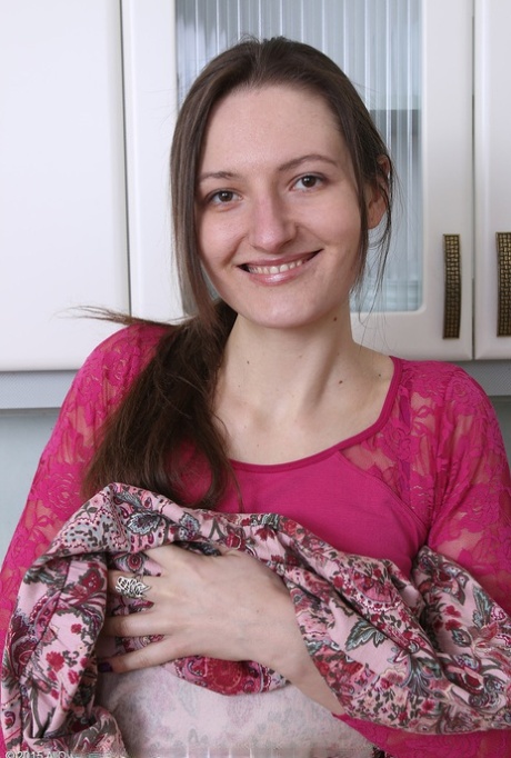 Slender brunette housewife Mariona strips to spread hairy pussy in the kitchen