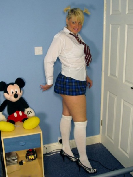 Older UK amateur Daniella English slides panties aside in schoolgirl attire