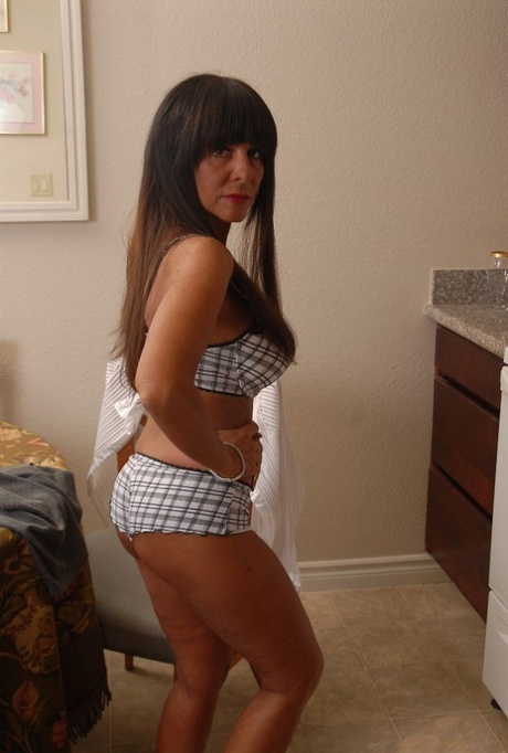 Mature brunette Cassidy flashing upskirt panties in the kitchen