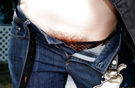 Mature redhead Lily Cade removes jeans and mesh undies to expose beaver