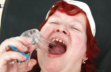 Chubby redhead granny masturbating her unshaven cunt in gyno office