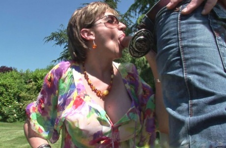Sultry mature slut in sunglasses sucks and fucks a hard cock outdoor