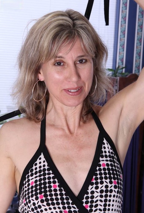 Slim mature lady undressing and exposing her hairy slit in close up