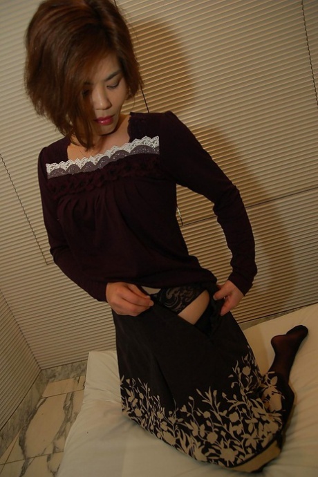 Asian lady Chika Ohara gets rid of her clothes and poses in sexy stockings