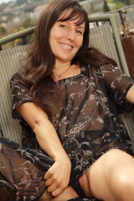 Kinky mature Carmen doffs her sheer dress and flaunts her hairy pussy