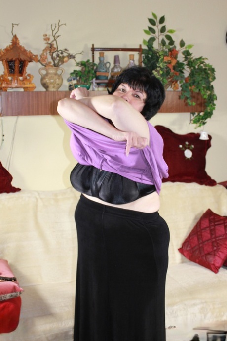 Raven-haired granny Eva unleashing her big tits and toying her mature cunt