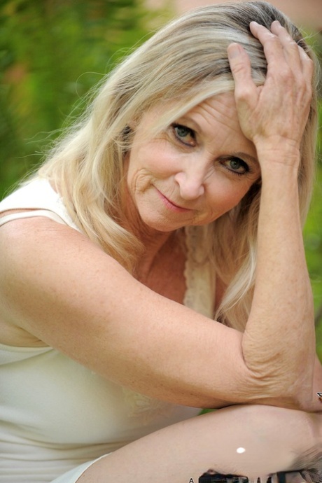 Blonde granny Annabelle Brady removes her dress & masturbates in the back yard
