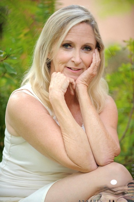 Blonde granny Annabelle Brady removes her dress & masturbates in the back yard