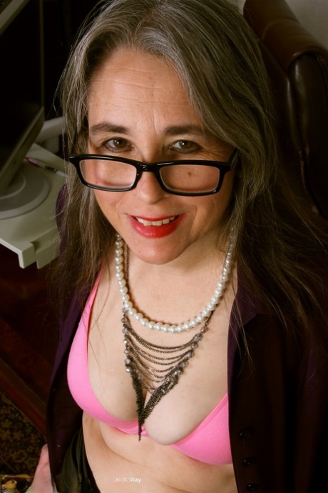 Nerdy mature Olivia Olay shows her big booty and big tits in a solo