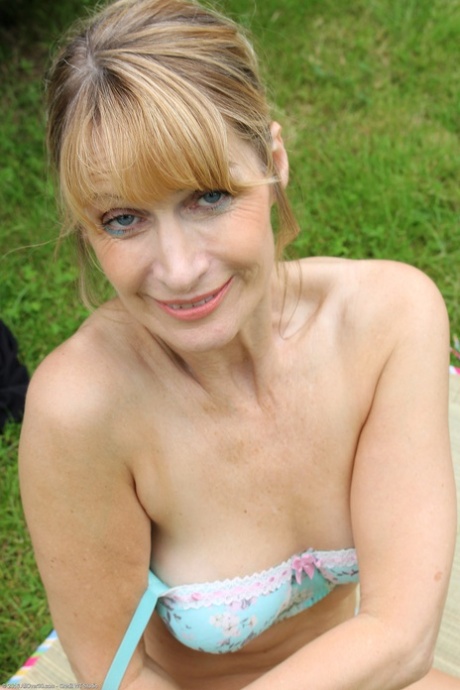 Flexible mature Jane B takes off her tights and teases with her big tits