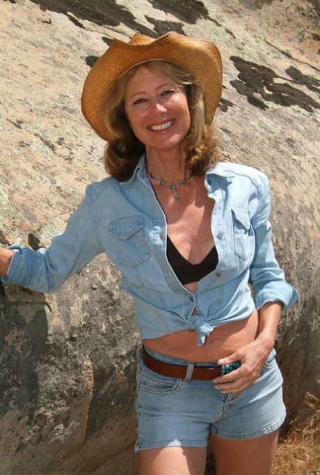 Mature cowgirl Janet strips on the mountain and shows her great curves