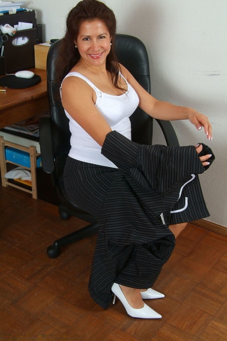 Charming mature lady Alexis stripping and posing seductively at the office