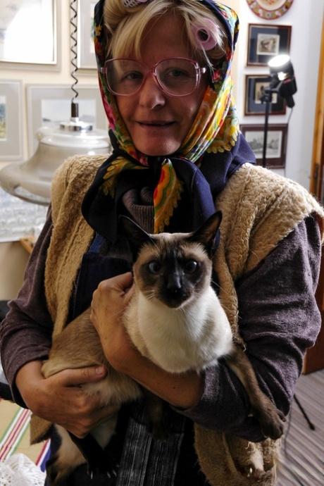 Granny with eyeglasses Christina toying her mature vagina on the carpet