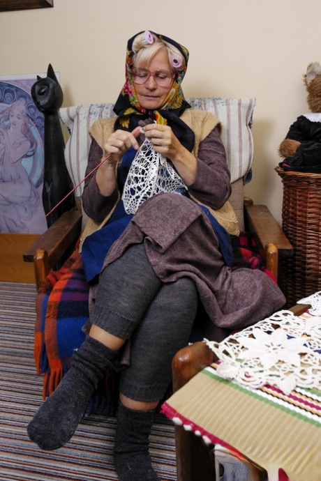Granny with eyeglasses Christina toying her mature vagina on the carpet
