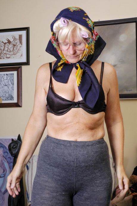 Granny with eyeglasses Christina toying her mature vagina on the carpet