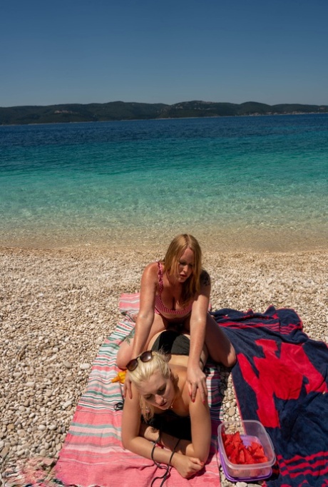 Old & young lesbians Mackenzie Page & Miss Melissa lick pussy at the beach