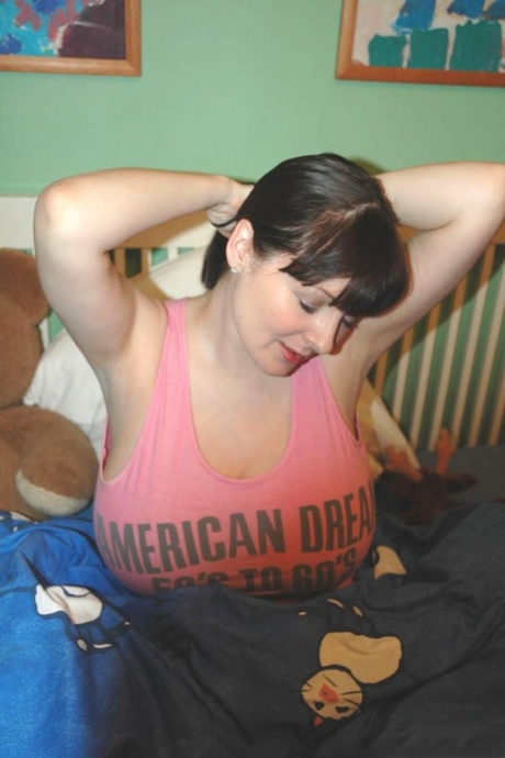 Dark haired amateur Lorna Morgan shows her huge boobs and stretches her ass