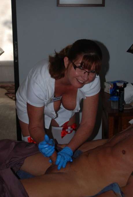 Mature nurse in glasses Vic Wonder gives a handjob wearing a hot uniform