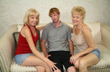 Blonde mature Tracy Lick and her swinger friend share a hot dick orally