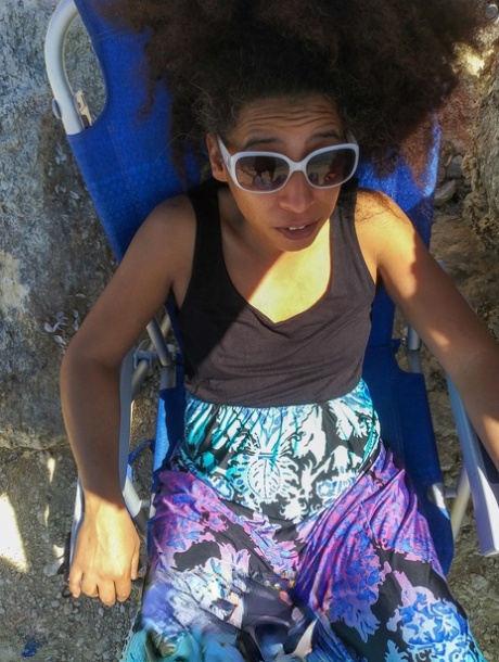 Mature ebony with hairy armpits Divine reveals her bushy cunt on the beach