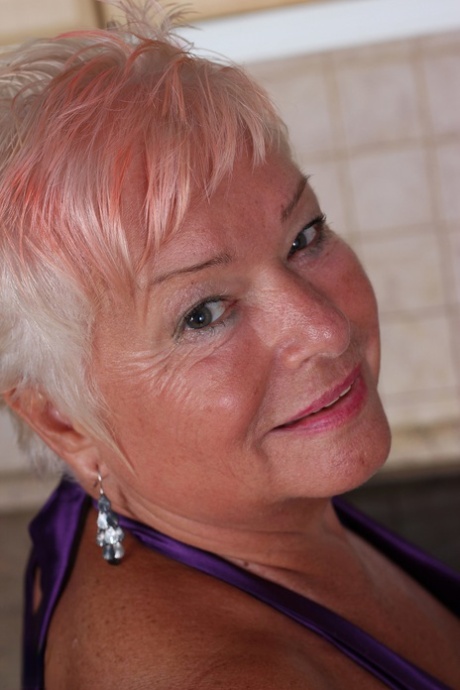 Short haired granny Verona M strips in the kitchen and fingers her old snatch